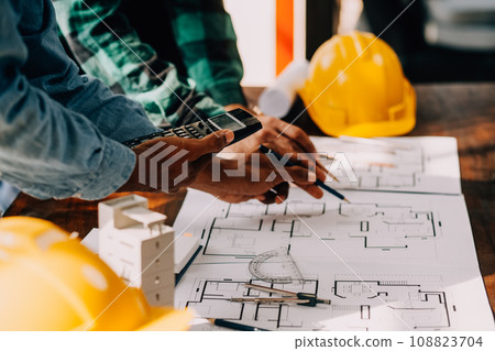Construction and structure concept of engineer working drawing on blueprint meeting for project working with partner on model building and engineering tools in working site, construction concept. 108823704