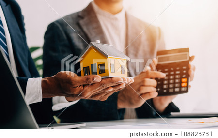 Real estate agent and customer signing contract to buy house, insurance or loan real estate.rent a house,get insurance or loan real estate or property. 108823731