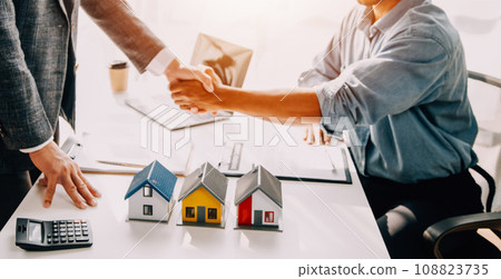 Real estate agent and customer signing contract to buy house, insurance or loan real estate.rent a house,get insurance or loan real estate or property. Real estate agent and customer signing contract to buy house, insurance or loan real estate.rent a house,get insurance or loan real estate or property. 108823735