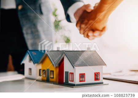 Real estate agent and customer signing contract to buy house, insurance or loan real estate.rent a house,get insurance or loan real estate or property. Real estate agent and customer signing contract to buy house, insurance or loan real estate.rent a house,get insurance or loan real estate or property. 108823739