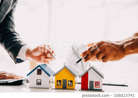 Real estate agent and customer signing contract to buy house, insurance or loan real estate.rent a house,get insurance or loan real estate or property. 108823741