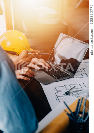 Construction and structure concept of engineer working drawing on blueprint meeting for project working with partner on model building and engineering tools in working site, construction concept. 108823773