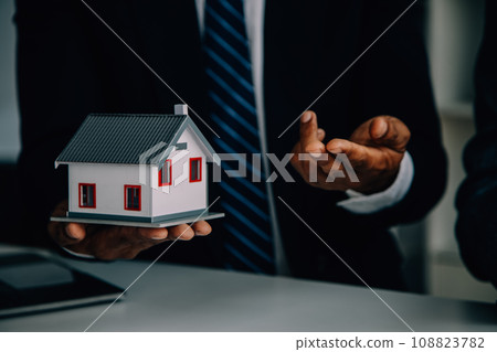 Real estate agent and customer signing contract to buy house, insurance or loan real estate.rent a house,get insurance or loan real estate or property. Real estate agent and customer signing contract to buy house, insurance or loan real estate.rent a house,get insurance or loan real estate or property. 108823782