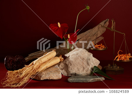 Abstract background for branding and minimal presentation with rare medicinal herbs. Ginseng root, cordyceps and lingzhi mushroom decorated with stones, dry twigs and red flower Abstract background for branding and minimal presentation with rare medicinal herbs. Ginseng root, cordyceps and lingzhi mushroom decorated with stones, dry twigs and red flower 108824589