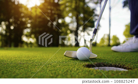 Blurred golfer playing golf in the evening golf course, on sun set evening time. 108825247