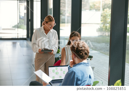 Businesspeople working together in modern coworking space. Teamwork concept 108825851