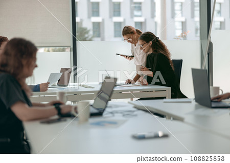 Business people working with laptops in office on colleagues background. Teamwork concept 108825858