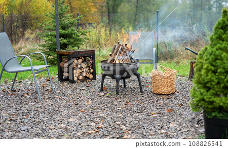 Fire pit and burning fire in a garden 108826541