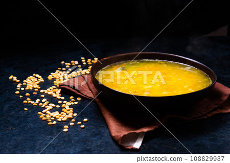 Appetizing hot pea soup and onion served with slices of bread Appetizing hot pea soup and onion served with slices of bread 108829987