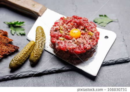 Savory beef tartare and brown bread toasts 108830731