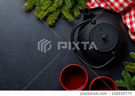 Teapot, cup, and fir tree branches create a cozy scene Teapot, cup, and fir tree branches create a cozy scene 108830775
