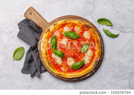 Margarita pizza with tomatoes, mozzarella cheese and basil 108830784