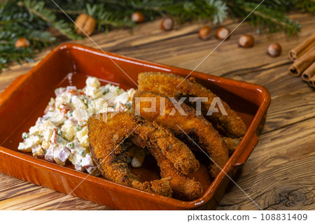 Traditional Christmas dinner in Czech Republic - fried carp with potato salad Traditional Christmas dinner in Czech Republic - fried carp with potato salad 108831409