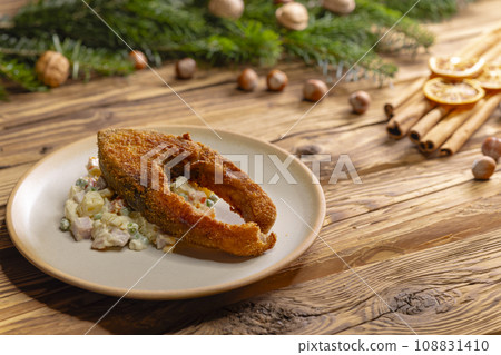 Traditional Christmas dinner in Czech Republic - fried carp with potato salad Traditional Christmas dinner in Czech Republic - fried carp with potato salad 108831410