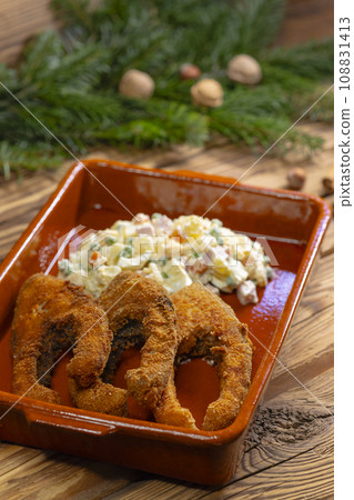 Traditional Christmas dinner in Czech Republic - fried carp with potato salad Traditional Christmas dinner in Czech Republic - fried carp with potato salad 108831413