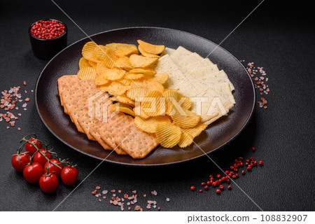 Crispy potato chips with salt, spices and herbs Crispy potato chips with salt, spices and herbs 108832907