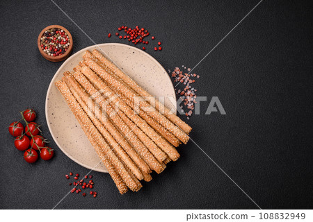 Delicious fresh grissini sticks with salt and sesame seeds 108832949