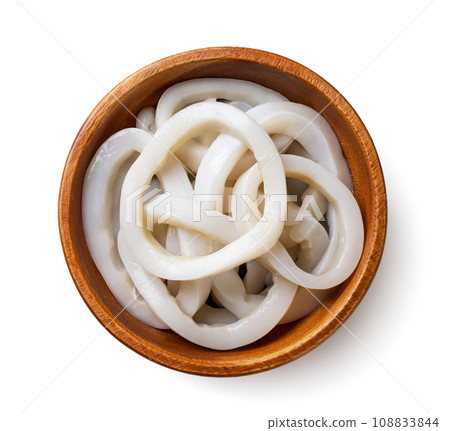 Squid rings in a wooden plate close-up on a white. Top view 108833844