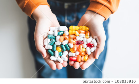 A woman holds in her hands bunch of Tablets, medical pills. Health and medicine, prevention and treatment of diseases A woman holds in her hands bunch of Tablets, medical pills. Health and medicine, prevention and treatment of diseases 108833910