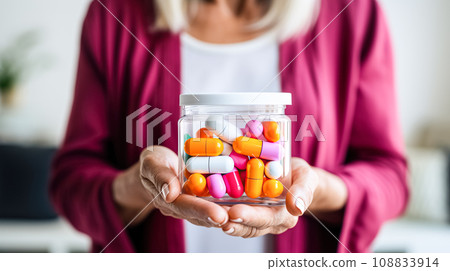 A woman holds in her hands jars with Tablets, medical pills. Health and medicine, prevention and treatment of diseases A woman holds in her hands jars with Tablets, medical pills. Health and medicine, prevention and treatment of diseases 108833914