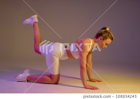 fitness motivated woman working out in white sports bra and shorts fitness motivated woman working out in white sports bra and shorts 108834243