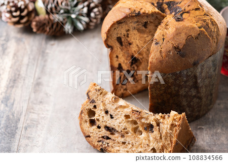 Christmas panettone cake with chocolate chips on wooden table Christmas panettone cake with chocolate chips on wooden table 108834566
