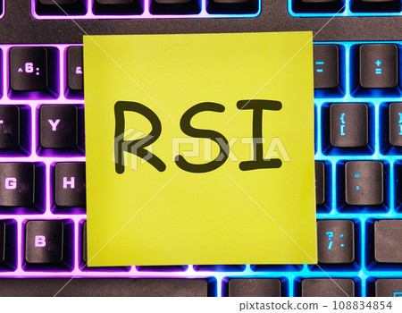 RSI Relative Strength Index written on a yellow sticker on a laptop keyboard with backlight RSI Relative Strength Index written on a yellow sticker on a laptop keyboard with backlight 108834854