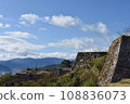 The stone walls of Takeda Castle ruins shine against the blue sky 108836073