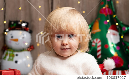 Portrait of two year old little Christmas blonde girl with blue eyes Portrait of two year old little Christmas blonde girl with blue eyes 108837027