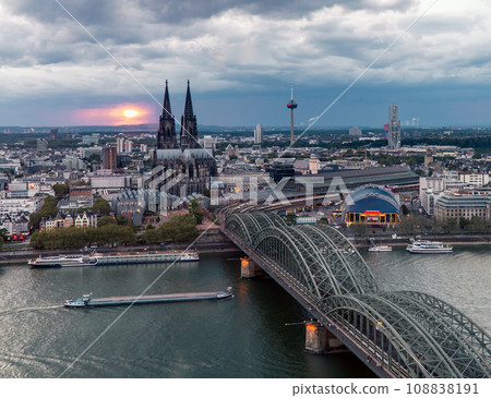 Dramatic storm clouds over Cologne Cathedral and Hohenzollern Bridge in the sunset 108838191
