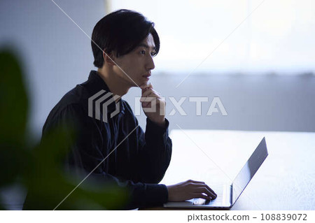 Japanese man using a laptop Japanese man using a laptop 108839072