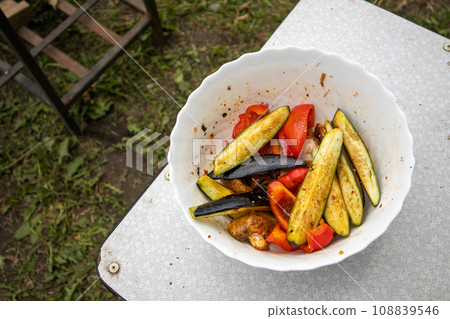 Delicious sliced grilled vegetables. Rustic background lawn and barbecue Delicious sliced grilled vegetables. Rustic background lawn and barbecue 108839546
