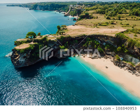 Aerial view of Balangan beach with rock and turquoise ocean in Bali. Aerial view of Balangan beach with rock and turquoise ocean in Bali. 108840953