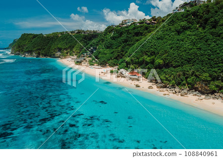 Tropical holidays beach with turquoise ocean in Bali. Aerial view of popular touristic beach 108840961