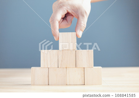 hand of a businessman stacking wood empty eight blocks with copy space for text or symbols, development concept for growth success process. 108841585