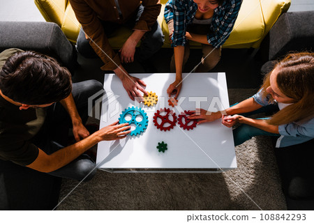 Business team work together and combine pieces of gears. Partnership and integration concept Business team work together and combine pieces of gears. Partnership and integration concept 108842293