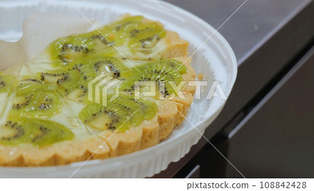 Pie with kiwi and berries. Sweet dessert with kiwi and berries, pastry with fruit. 108842428