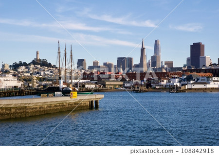 SAN FRANCISCO, CALIFORNIA, UNITED STATES - NOVEMBER 26, 2018: View of downtown San Francisco from the water with the piers in the foreground and the Transamerica Pyramid in the background SAN FRANCISCO, CALIFORNIA, UNITED STATES - NOVEMBER 26, 2018: View of downtown San Francisco from the water with the piers in the foreground and the Transamerica Pyramid in the background 108842918