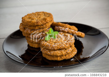 cooked sweet oatmeal cookies on wooden table cooked sweet oatmeal cookies on wooden table 108843210