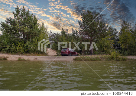 Red SUV car in a sand pit. Red SUV car in a sand pit. 108844413