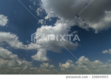 White puffy cumulus clouds on summer blue sky 108844955