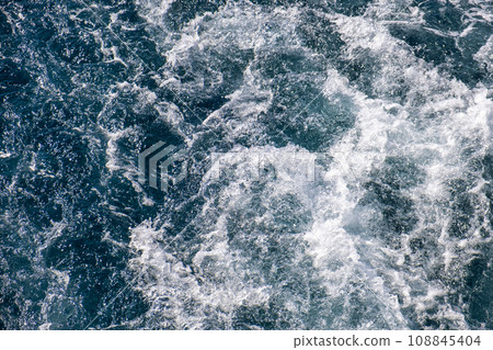 Top down aerial view of sea water surface. White foam waves texture as natural background. Top down aerial view of sea water surface. White foam waves texture as natural background. 108845404