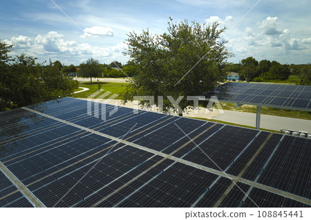 Solar panels installed over parking lot for parked cars for effective generation of clean energy 108845441