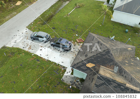 Natural disaster and its consequences. Hurricane Idalia destroyed house roof in Florida residential area 108845832