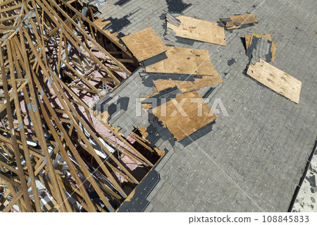 Natural disaster and its consequences. Hurricane Ian destroyed house roof in Florida residential area 108845833