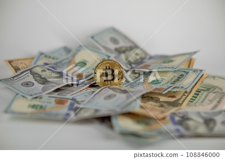 Golden symbolic coin Bitcoin on banknotes of one hundred dollars. Exchange bitcoin cash for a dollars. Cryptocurrency on US dollar bills. Digital modern method of payment. Savings, investments concept Golden symbolic coin Bitcoin on banknotes of one hundred dollars. Exchange bitcoin cash for a dollars. Cryptocurrency on US dollar bills. Digital modern method of payment. Savings, investments concept 108846000