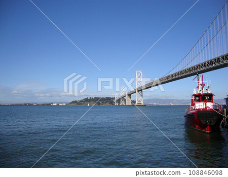 Fireboat docked in front of the Bay Bridge 108846098
