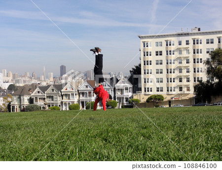 Handstanding in front of the painted ladies buildings of San Francisco 108846100