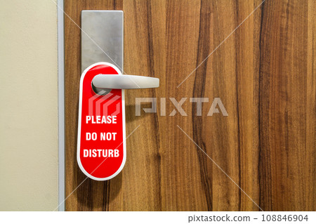 Door of hotel room with sign please do not disturb. Door of hotel room with sign please do not disturb. 108846904