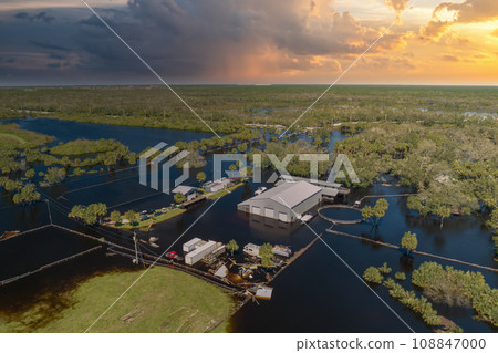Consequences of natural disaster. Flooded industrial business warehouse by hurricane Ian rainfall in Florida rural area Consequences of natural disaster. Flooded industrial business warehouse by hurricane Ian rainfall in Florida rural area 108847000
